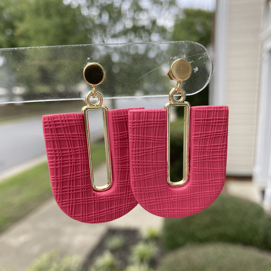 Dark strawberry red polymer clay arch earrings with mismatched red and gold posts, featuring gold-plated rectangle accents, handcrafted in Charlotte NC by Wendy Varner Designs.