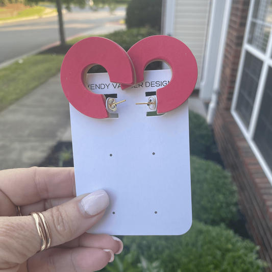 Raspberry pink chunky polymer clay earrings with bold circular cutout, handmade and mounted on product card