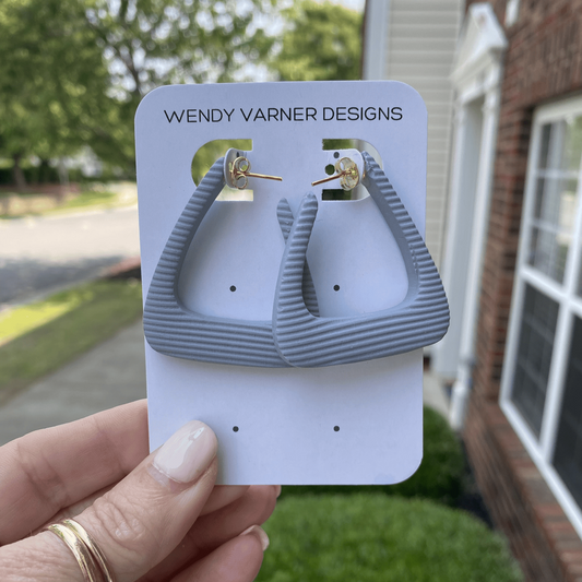 Modern triangle polymer clay earrings in matte grey finish with gold posts, handmade in Charlotte, NC