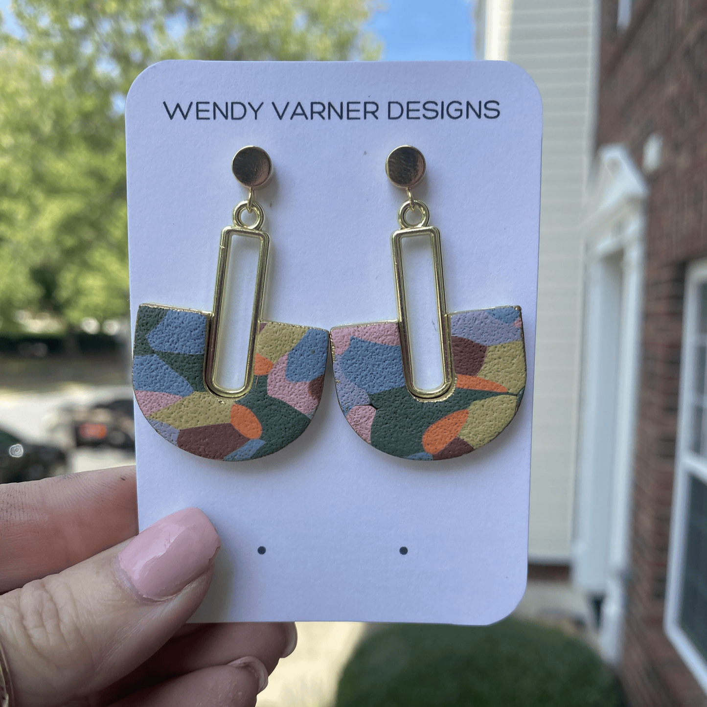 Handmade multi-colored arch polymer clay earrings shown on Wendy Varner Designs earring card