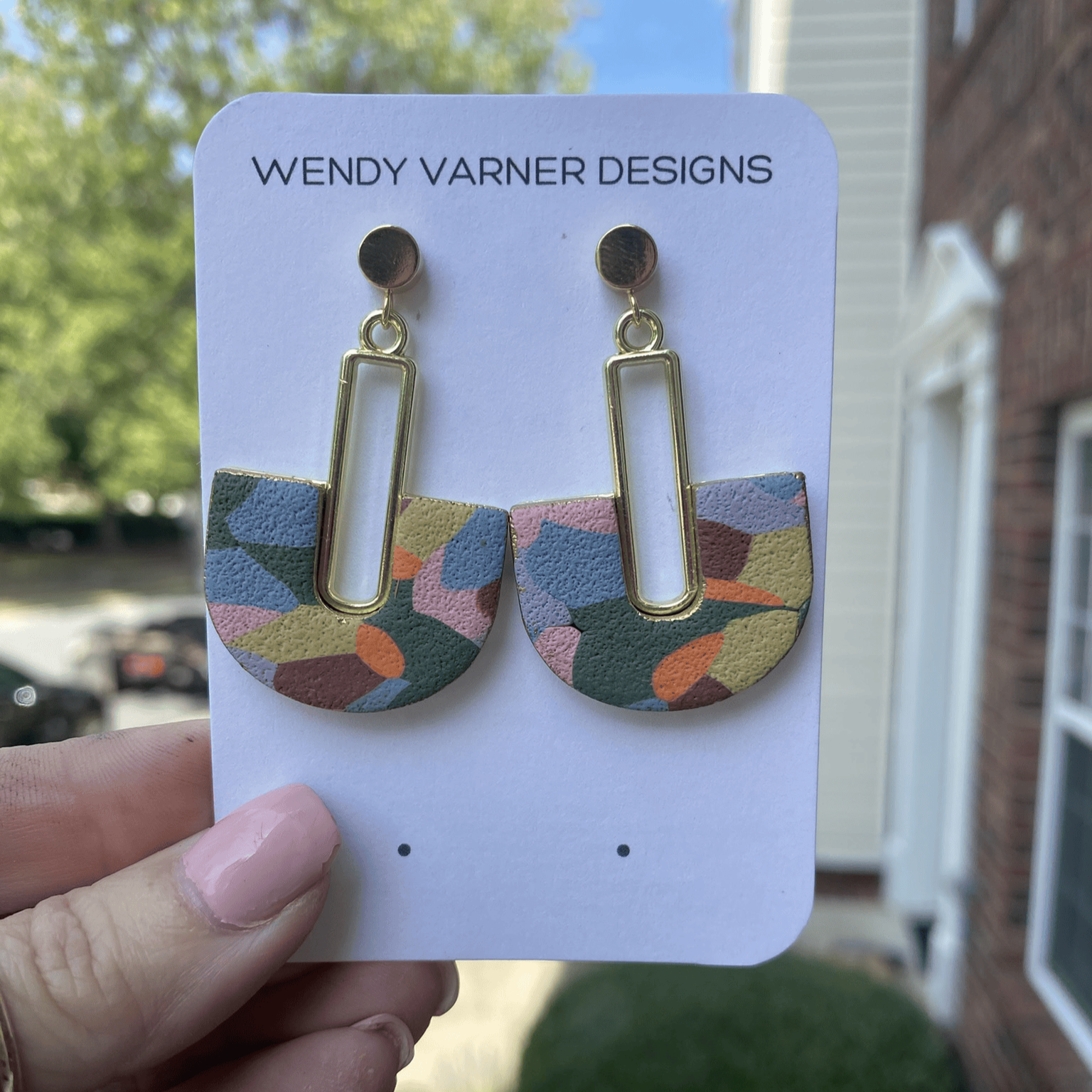 Handmade multi-colored arch polymer clay earrings shown on Wendy Varner Designs earring card