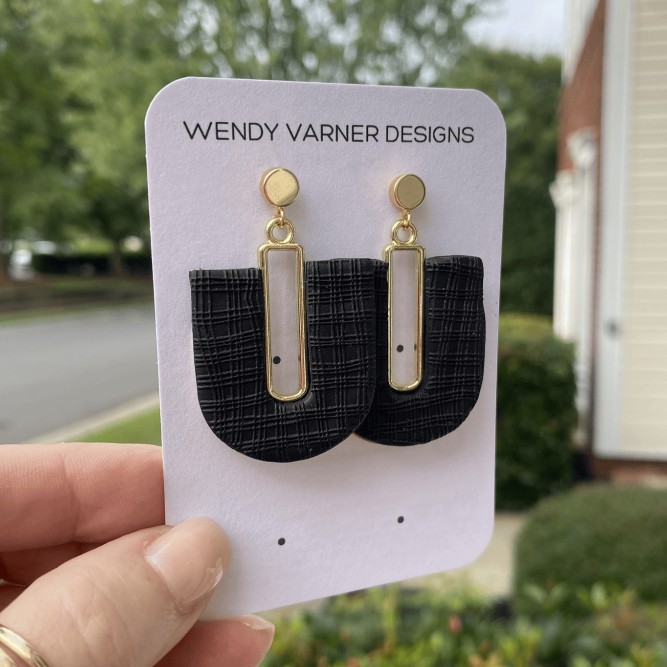 Black plaid textured polymer clay arch earrings with gold posts, handmade by Wendy Varner Designs in Charlotte NC.