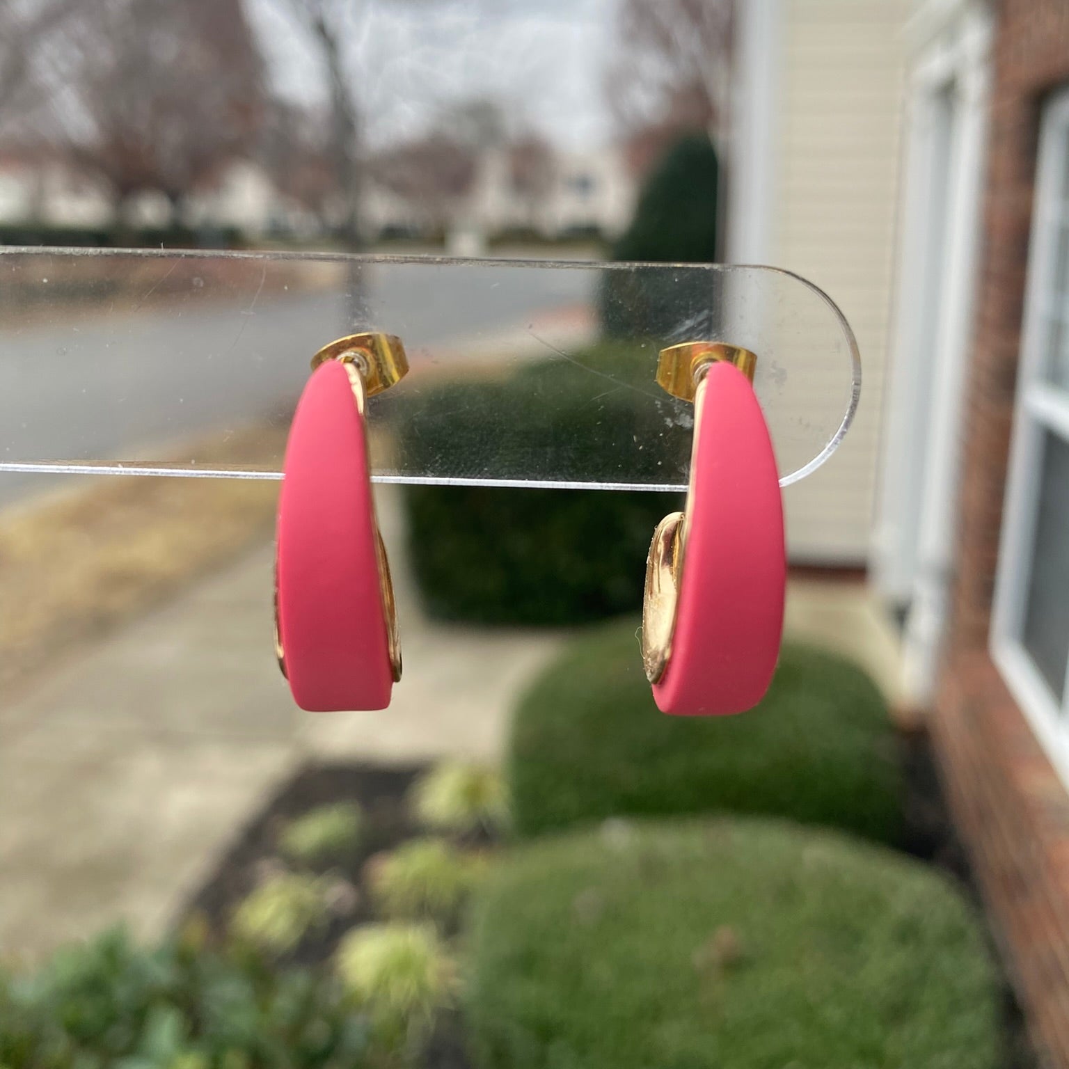 Close-up photo of pink blush polymer clay hoops with gold inner curve, lightweight handmade earrings