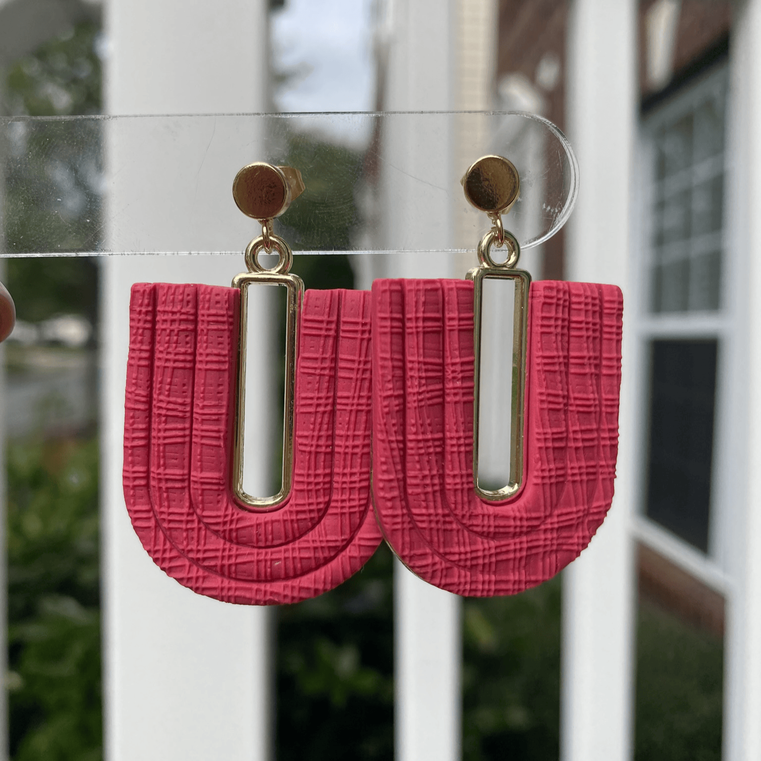 Dark strawberry red textured polymer clay arch earrings with gold-plated rectangle accents and gold posts, handmade by Wendy Varner Designs in Charlotte NC.