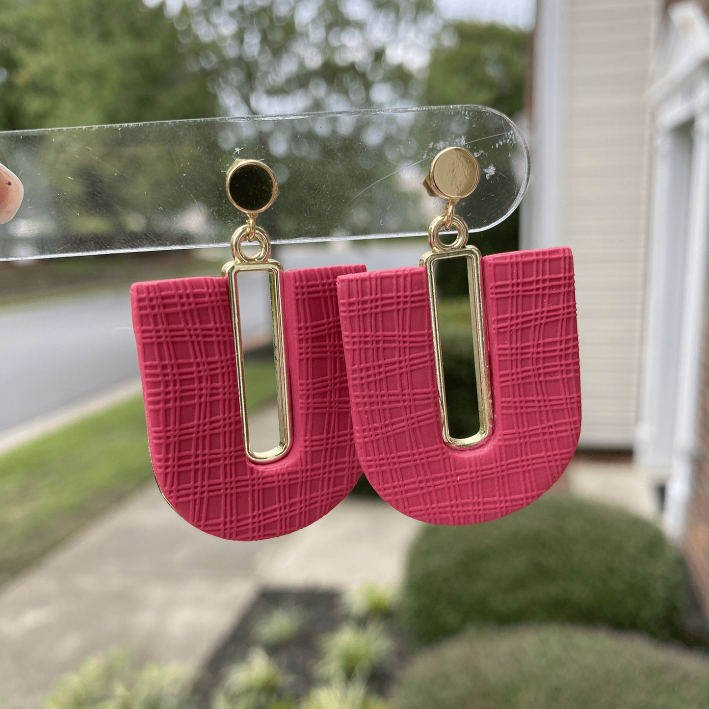 Dark strawberry red textured polymer clay arch earrings with gold-plated rectangle accents and gold posts, handmade by Wendy Varner Designs in Charlotte NC.