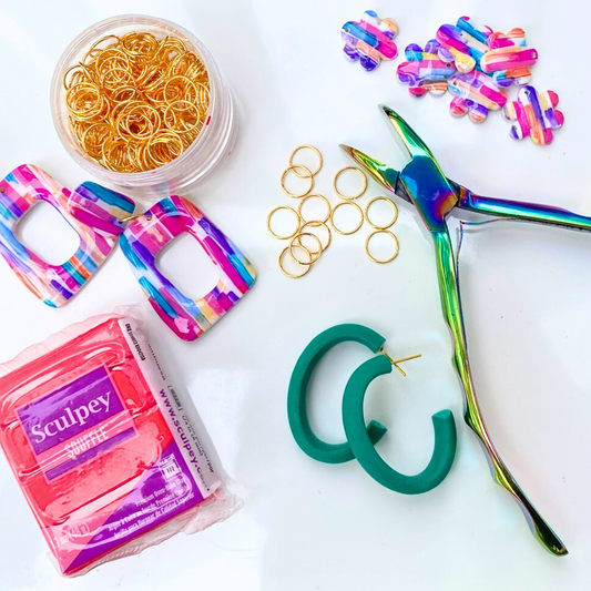 Flat lay of handmade polymer clay earrings on white background, representing DIY earring workshop with Wendy Varner Designs in Charlotte North Carolina