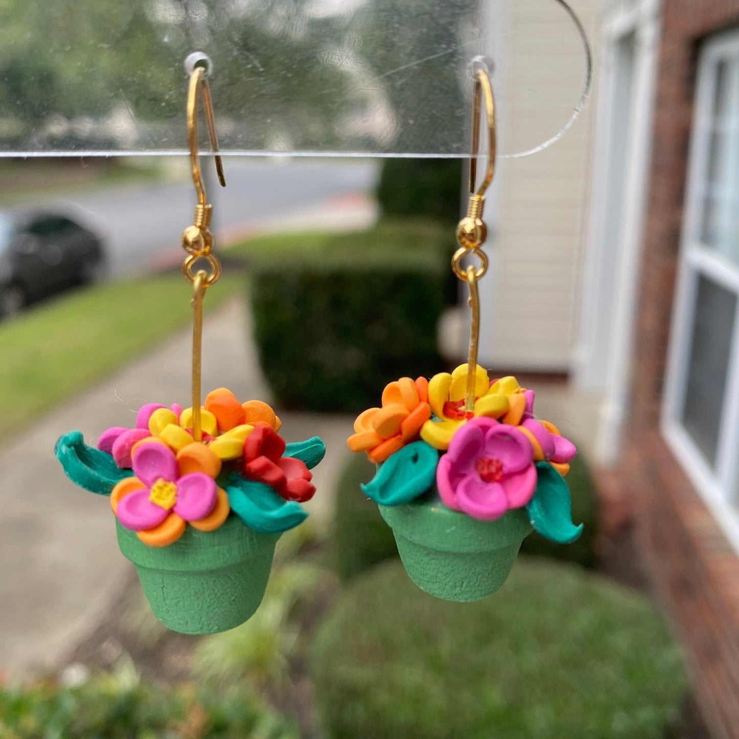 Hand-crafted polymer clay earrings shaped like green flower pots with colorful flowers, from the Hawaiian Paradise collection.