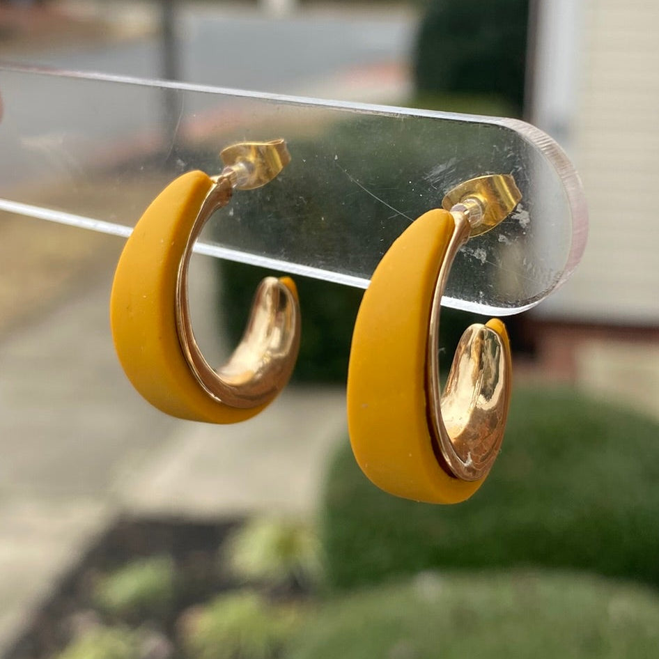 Side angle of mustard yellow and gold textured polymer clay hoop earrings