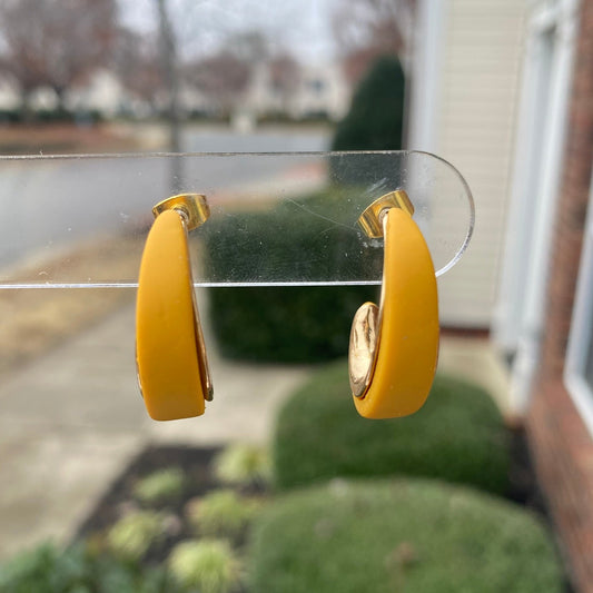 Close-up photo of mustard yellow polymer clay hoops with gold inner curve, lightweight handmade earrings