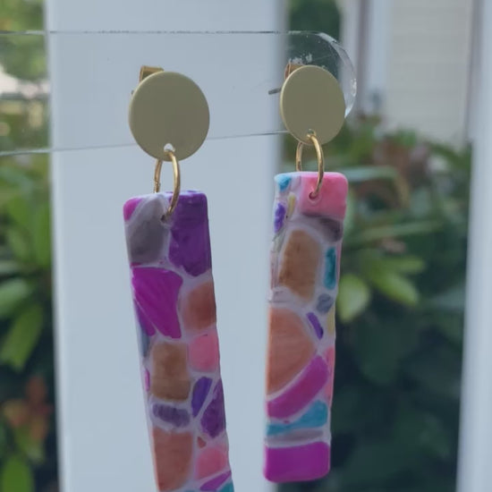 Cobble polymer clay earrings with a vibrant mosaic pattern in pink, purple, orange, and turquoise from The Brush Stroke collection