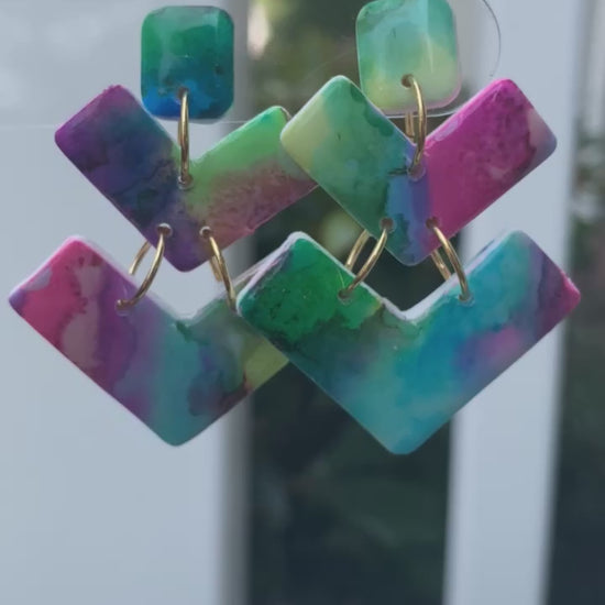 Bolt polymer clay earrings with vibrant teal, pink, green, and purple geometric shapes from The Brush Stroke collection