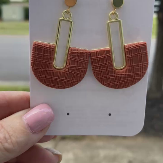 Handmade terracotta arch polymer clay earrings on earring card, gold accents.