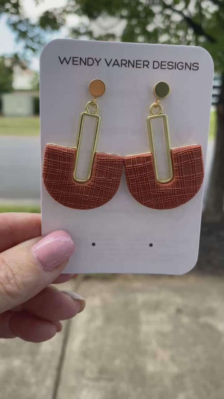 Handmade terracotta arch polymer clay earrings on earring card, gold accents.