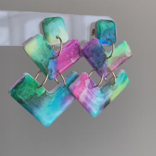 Bolt polymer clay earrings with vibrant teal, pink, green, and purple geometric shapes from The Brush Stroke collection