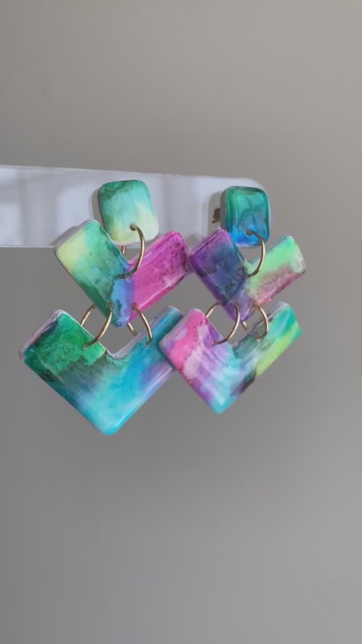 Bolt polymer clay earrings with vibrant teal, pink, green, and purple geometric shapes from The Brush Stroke collection