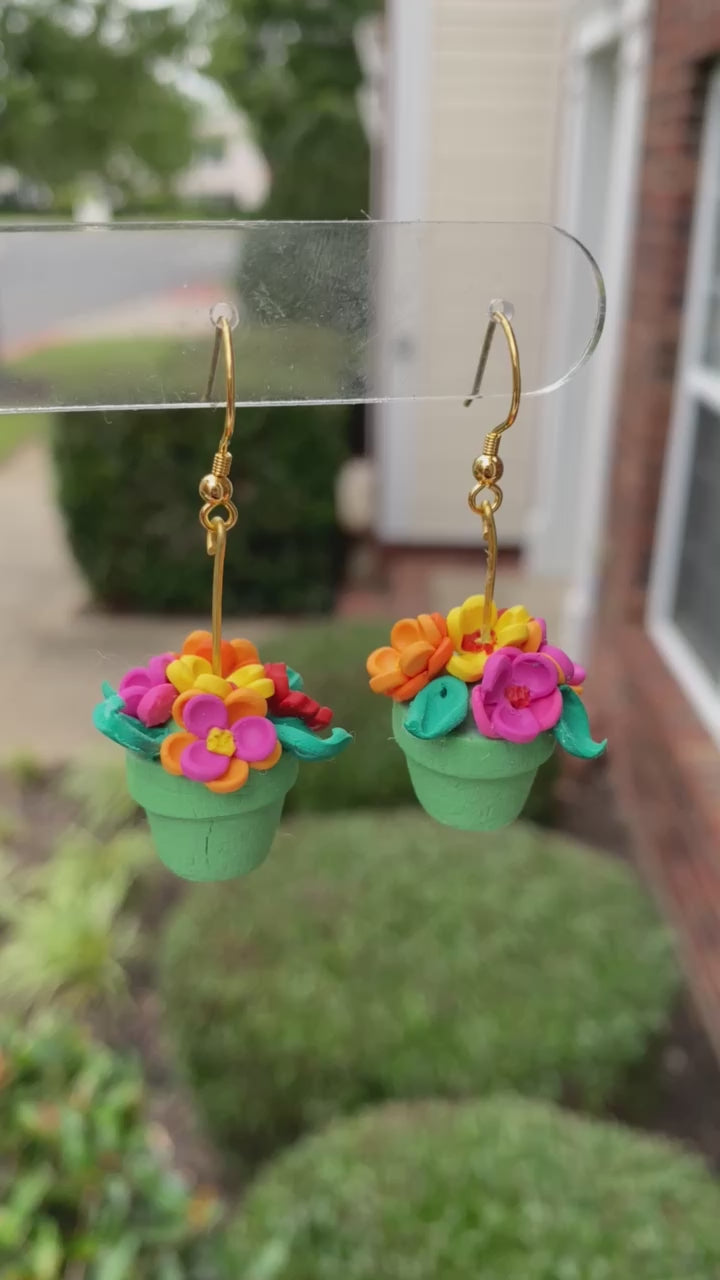 Hand-crafted polymer clay earrings shaped like green flower pots with colorful flowers, from the Hawaiian Paradise collection.