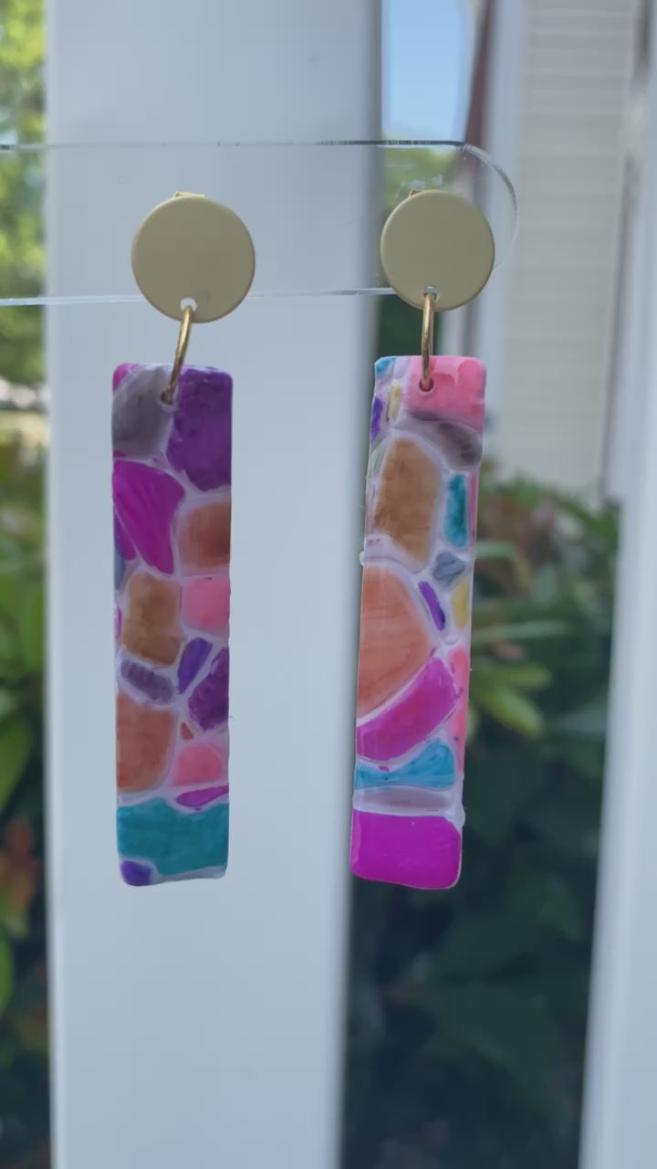 Cobble polymer clay earrings with a vibrant mosaic pattern in pink, purple, orange, and turquoise from The Brush Stroke collection