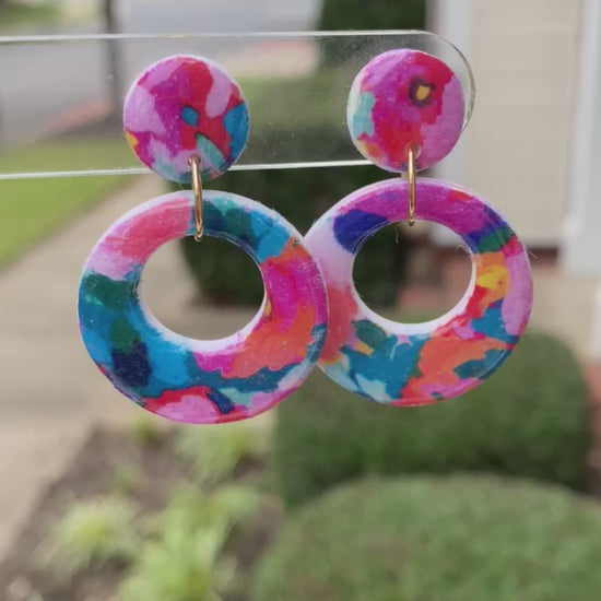 Round polymer clay earrings with colorful, abstract floral patterns in a circular cut-out design, from the Hawaiian Paradise collection.