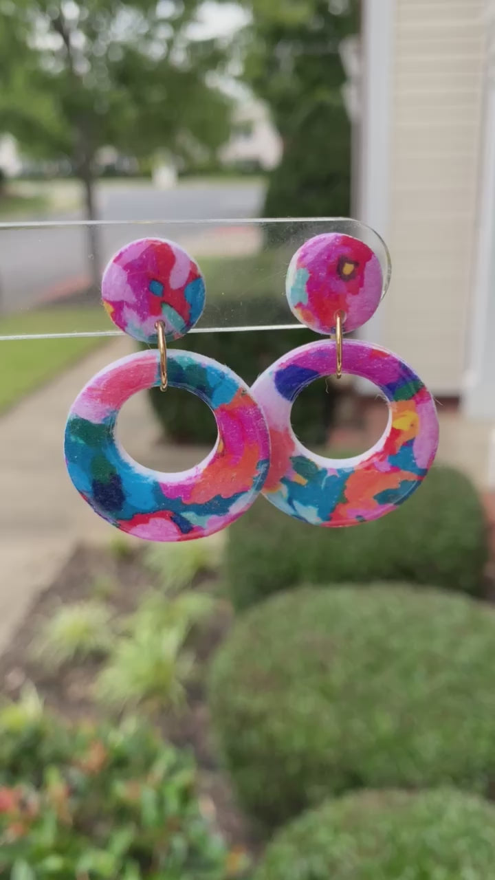 Round polymer clay earrings with colorful, abstract floral patterns in a circular cut-out design, from the Hawaiian Paradise collection.