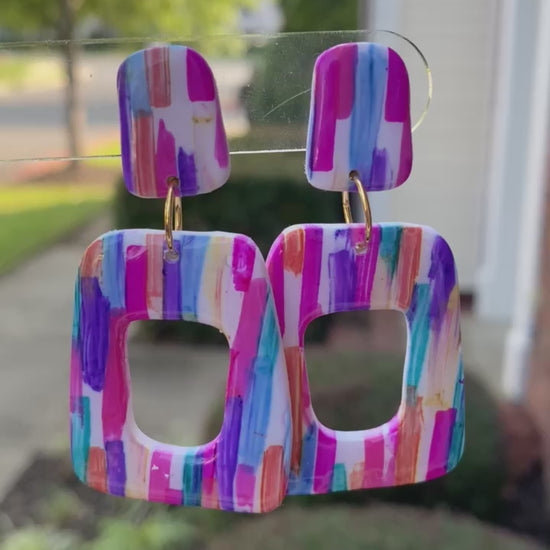 Stroke polymer clay earrings featuring a colorful brushstroke pattern in pink, blue, and orange from The Brush Stroke collection