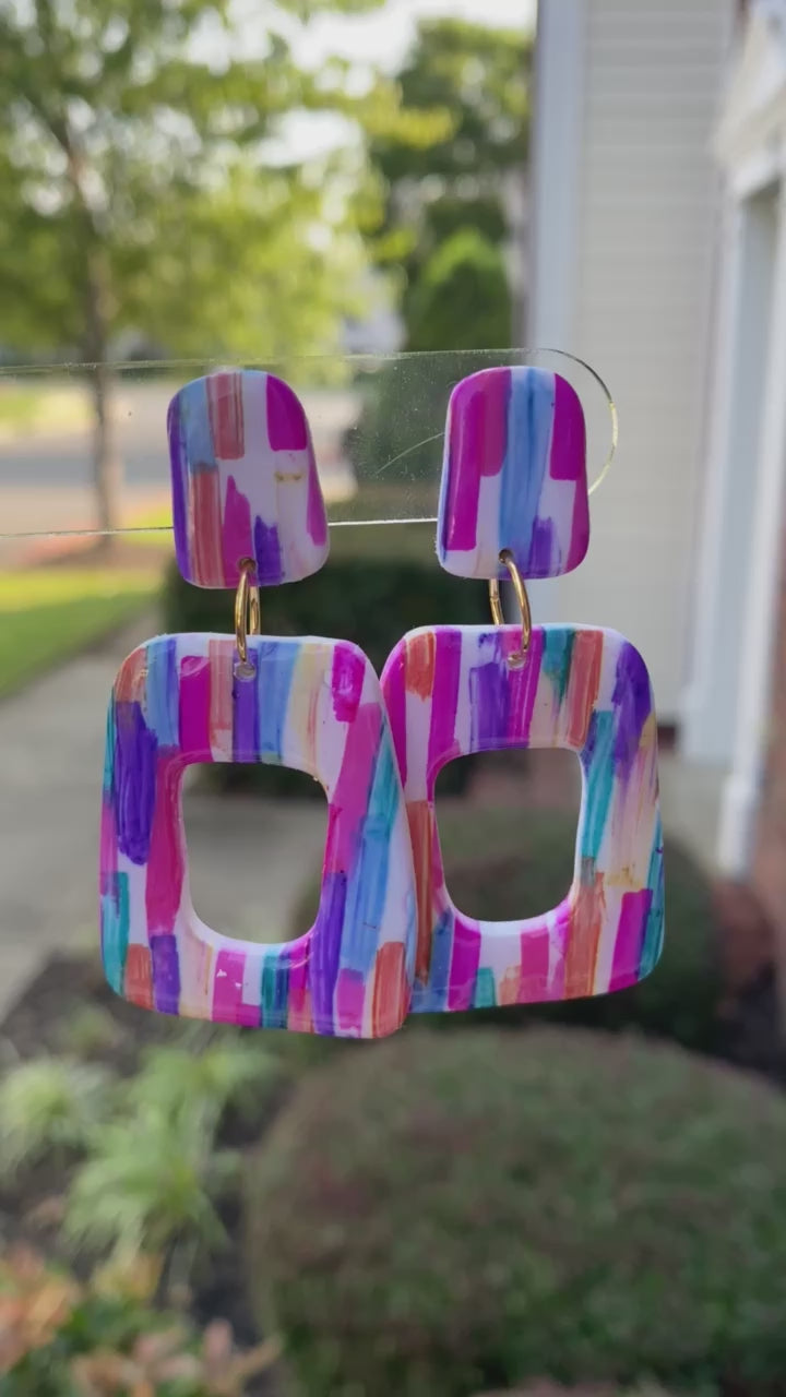 Stroke polymer clay earrings featuring a colorful brushstroke pattern in pink, blue, and orange from The Brush Stroke collection