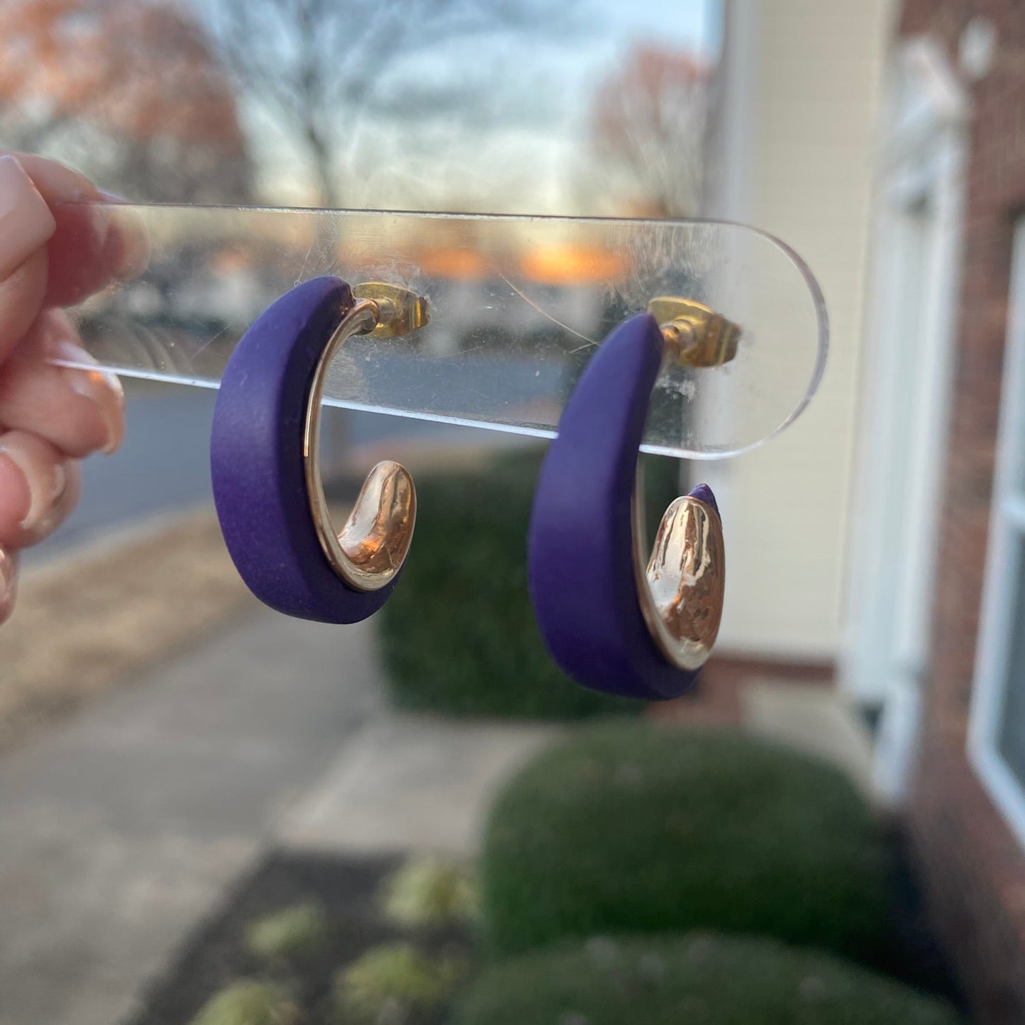 Side angle of purple and gold textured polymer clay hoop earrings