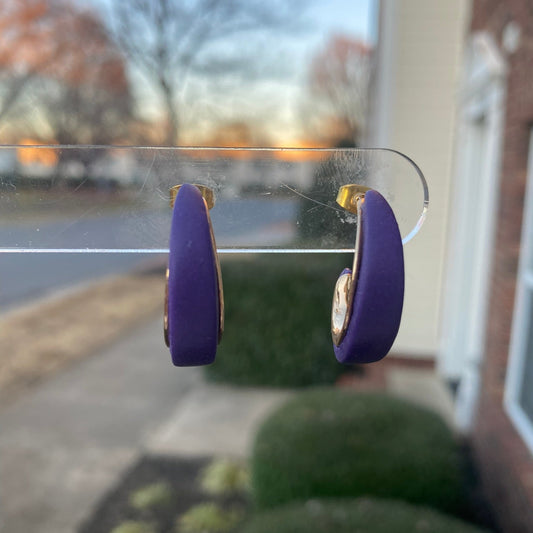 Purple and gold polymer clay hoop earrings displayed outdoors on clear stand, handmade by Wendy Varner Designs 