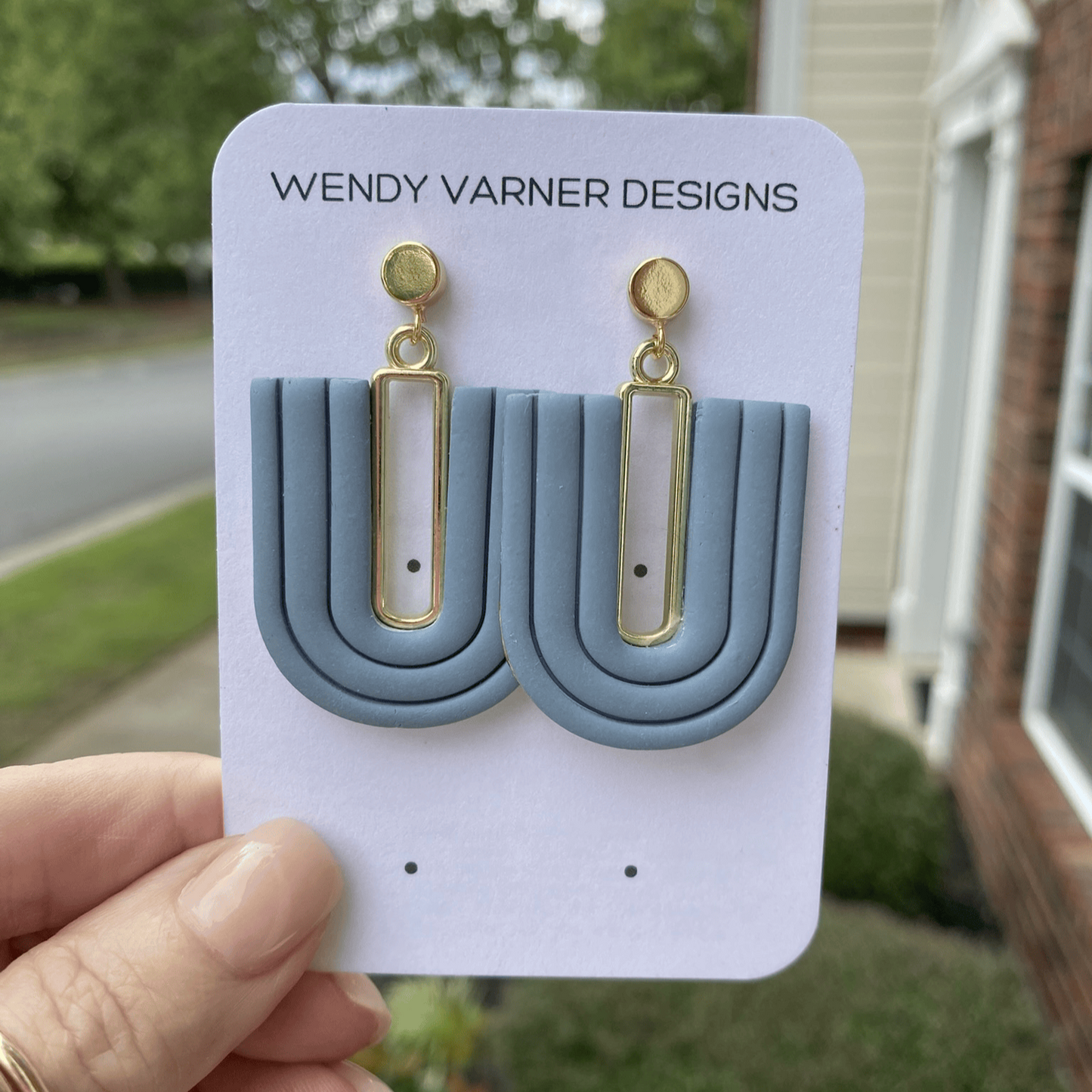 Handmade steel blue U-arch polymer clay earrings displayed on Wendy Varner Designs card.