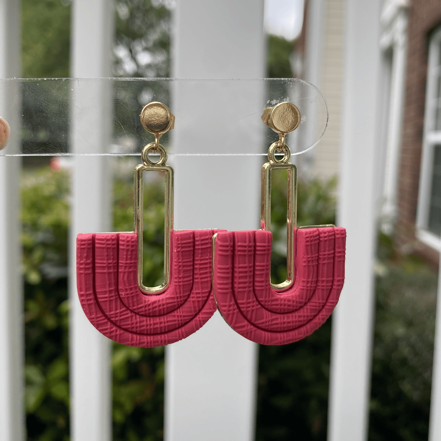 Strawberry Red half-arch polymer clay earrings with gold-plated connector on earring card – handmade in Charlotte NC.