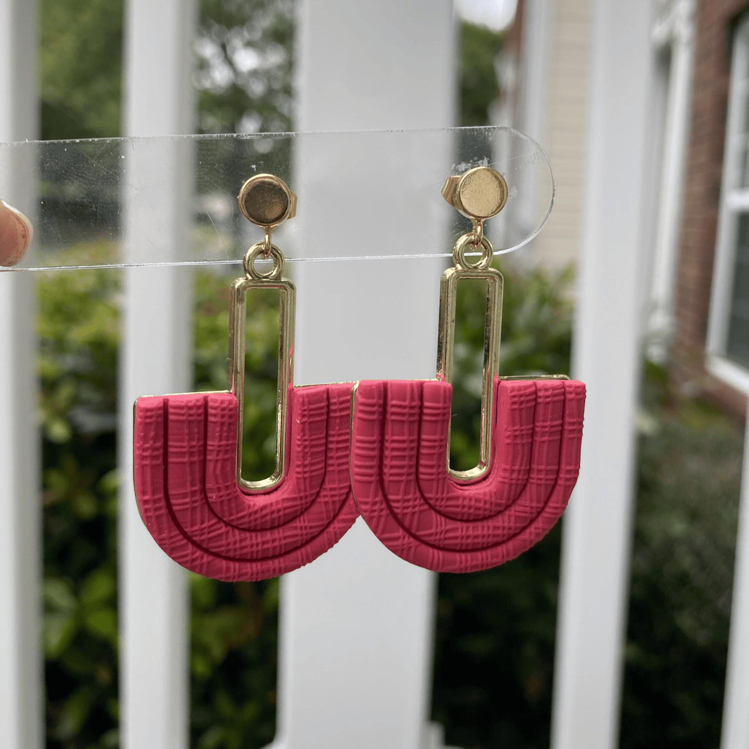 Side view of Strawberry Red half-arch polymer clay earrings with gold-plated connector – handmade jewelry Charlotte NC.
