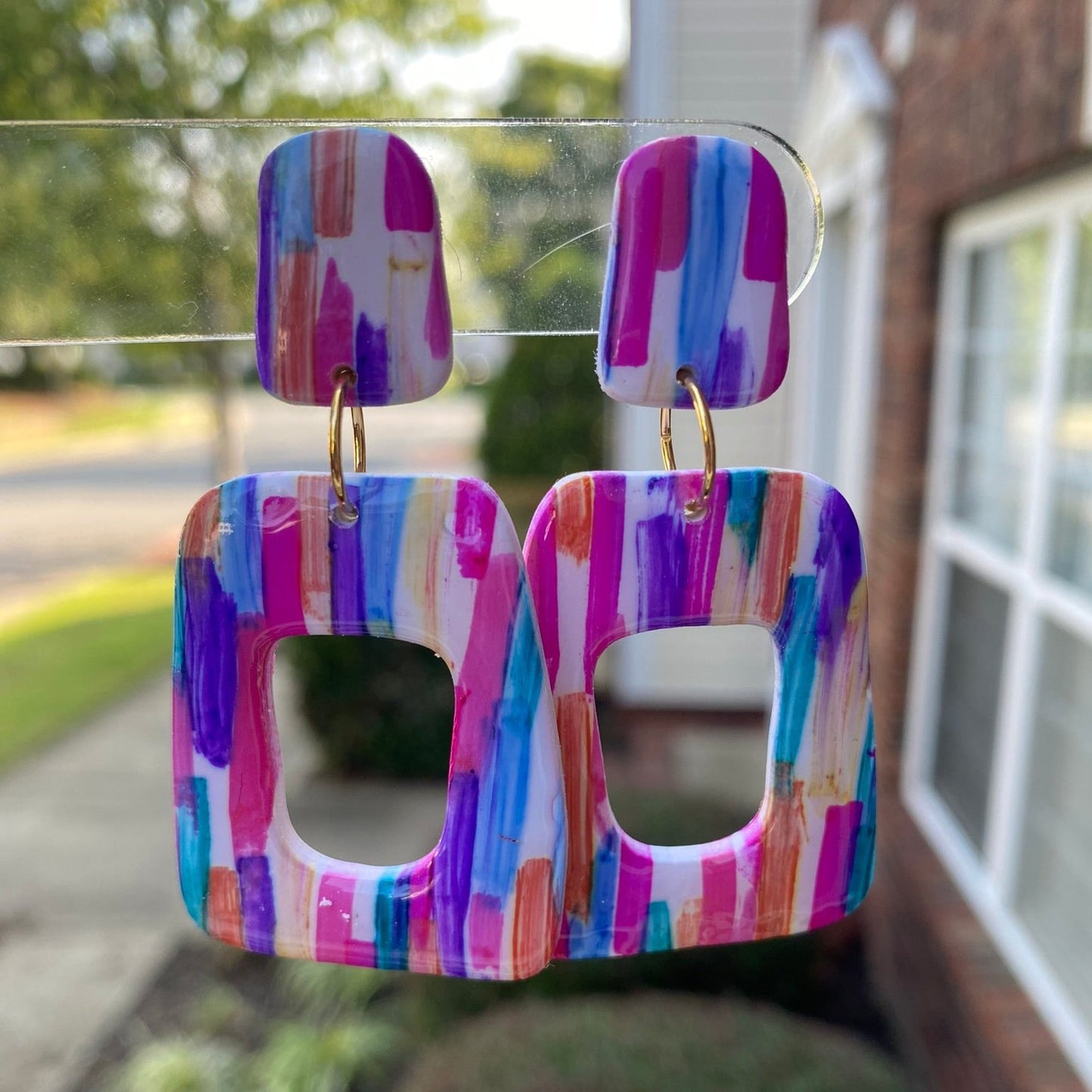 Stroke polymer clay earrings featuring a colorful brushstroke pattern in pink, blue, and orange from The Brush Stroke collection