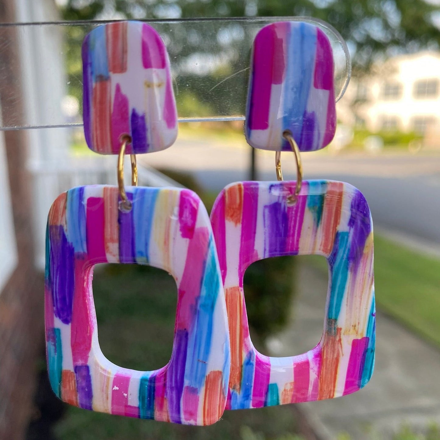 Stroke polymer clay earrings featuring a colorful brushstroke pattern in pink, blue, and orange from The Brush Stroke collection