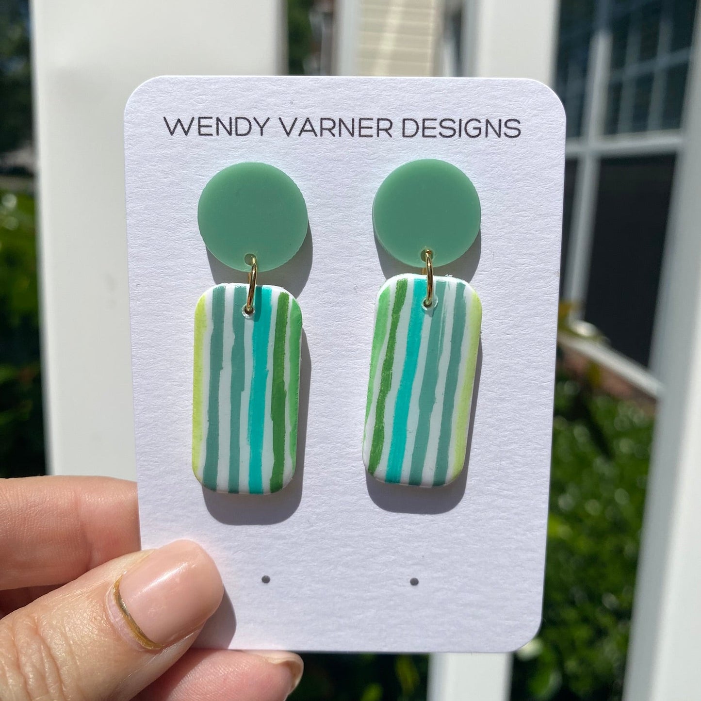 Handcrafted polymer clay dangle earrings in mint, teal, olive, and chartreuse stripes on a Wendy Varner Designs earring card